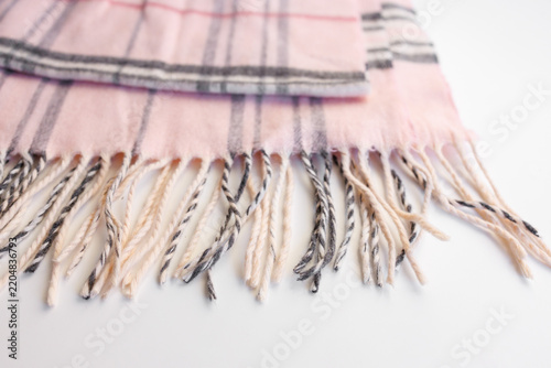Obraz na płótnie Pink plaid scarf fringe close up on white background