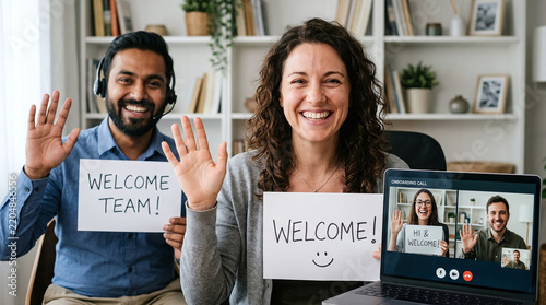 Diverse business team holding sign greeting new employee on video conference call