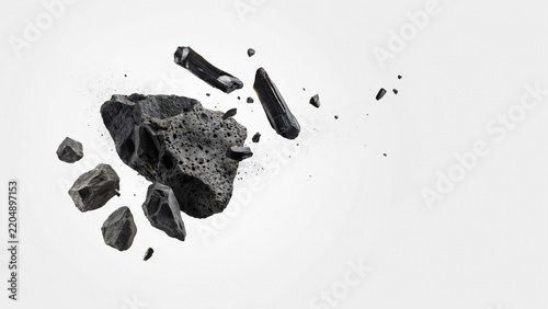 Fragments of black charcoal scattering across white studio space with charcoal fragments scattering material industrial resource particulate formation abstract as clean cutout