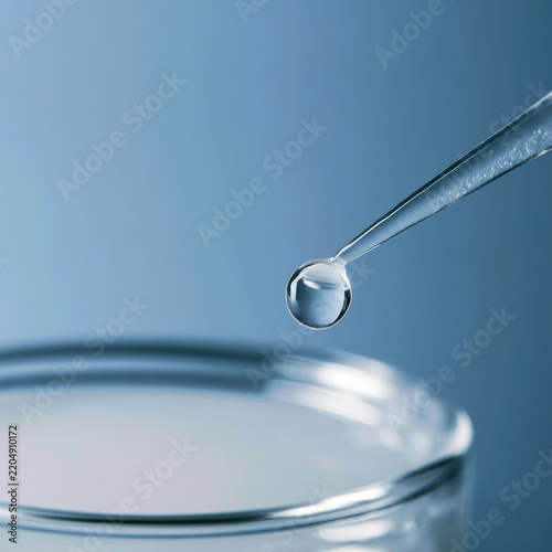 Milk droplet sterile pipette laboratory liquid glass dish macro photography showing reflective droplet above clean sample vessel for scientific testing and precise fluid analysis