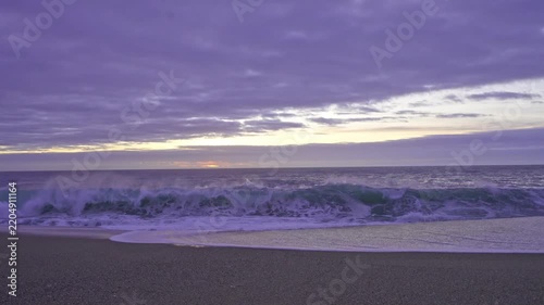 Powerful Atlantic waves crashing onto the sandy beach of Nazare