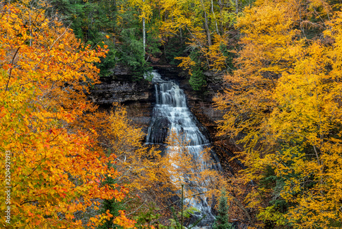 Brilliant Fall color frames Chapel Falls at Pictured Rocks National Lakeshore, Michigan, USA