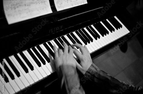 Hands playing a piano