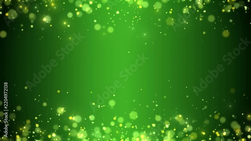 Video animation of golden glitter particles with defocused bokeh over green background. Abstract moving background - seamless loop - christmas and vacation concept.