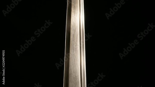 Close up panning shot of bronze sculpture sword and blindfolded figure
