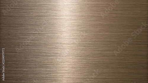 Brushed bronze metal texture with horizontal lines reflecting soft light for backgrounds and design elements