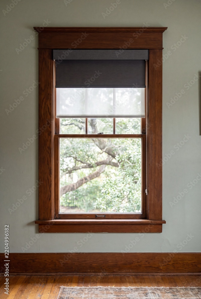 Fototapeta premium Original Wood Window With Motorized Blackout Shade and Oak Casing