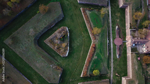 Aerial view of the Vauban walled city of Neuf-Brisach with its distinctive star-shaped fortifications, stone ramparts, and autumn trees in Neuf-Brisach, Grand Est, France.