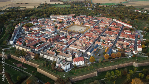 Aerial view of the Vauban walled city of Neuf-Brisach, showcasing its historic star-shaped fortifications, dense red-tiled rooftops, and central square in Neuf-Brisach, Grand Est, France.