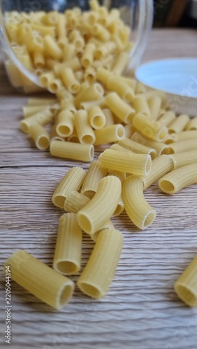 Pasta spilled from a jar onto the table