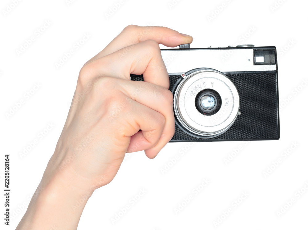Obraz premium Hand holding retro photo camera isolated on transparent background, front view, retro things concept