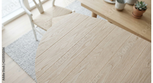 Round oak table surface with wooden chair and succulent plant interior