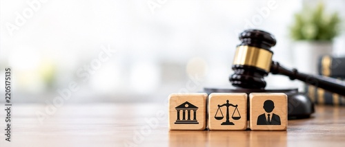 Wooden gavel and law icons on blocks in office with copy space