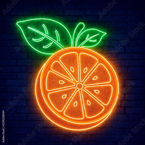 Bright orange and green neon sign shaped like a citrus fruit slice with leaves