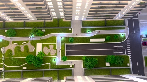 Detailed architectural scale model of a modern apartment building with glowing interior lights, landscaped green courtyard, pathways, and underground garage ramp. 4K video.