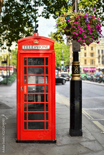 Classic London red telephone booth and flowers on lamp post