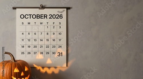A monthly calendar for October 2026 hangs on a textured gray wall, prominently displaying the 31st with a carved jack-o'-lantern casting a spooky shadow below.