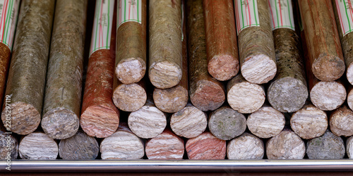 Stacked cylindrical geological core drill samples showing varied rock layers and colors