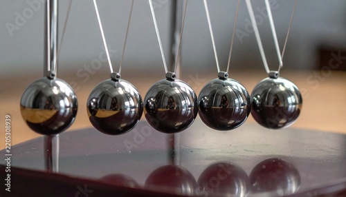 motion physics illustration by newton cradle chrome sphere
