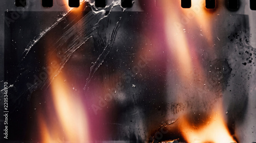 A high-resolution background featuring a damaged vintage film strip with realistic light leaks, heavy scratches, dust particles, and burnt edges.