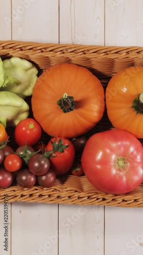 Colorful Garden Vegetables Fill Harvest Basket Flat Lay Stop Motion Vertical Video