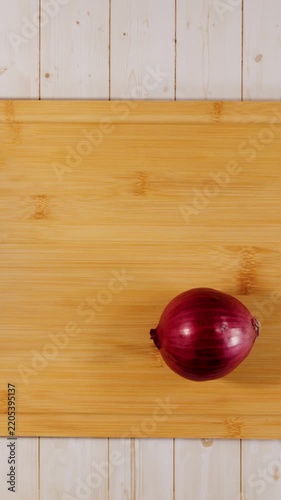 Red Onion Slicing Itself on Cutting Board Flat Lay Stop Motion Animation Vertical Video