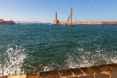 Sailboat and Venetian Lighthouse in Chania Harbor, Crete, Greece