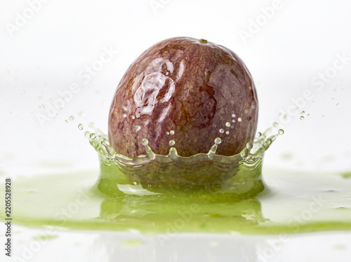 Halved Passion Fruits with Yellow Juice Splash