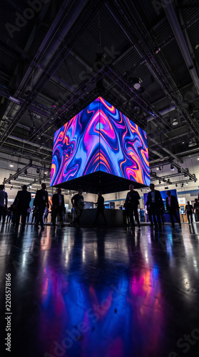Large LED cube screen glowing at trade show convention center