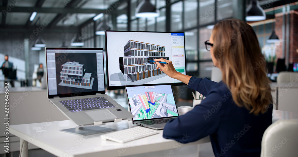 Obraz premium Architect Studies Detailed 3D BIM Model On Laptop
