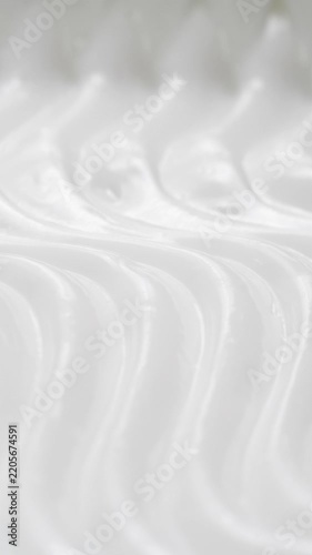 Vertical closeup white eye, skin cream texture background, facial cosmetics mask