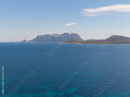 Aerial view of the island of Tavolara rising from the turquoise Tyrrhenian Sea off the coast of Sardinia, Pittulongu, Sardinia, Italy.