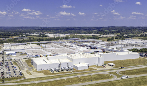 Aerial view of the General Motors Spring Hill Manufacturing facility featuring large industrial buildings, parking lots, and surrounding green landscape in Nashville, TN, United States.