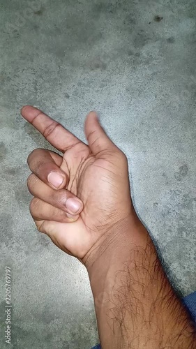 Male hand displaying a metaphorical finger gun gesture, symbolizing targeting, clicking, or aiming at a business objective