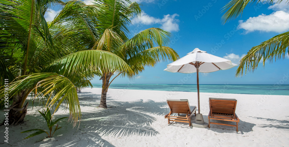 Obraz premium Romantic tropical beach wooden sunbeds white umbrella palm trees turquoise sea sandy shore sunny paradise. Perfect summer vacation travel scene. Luxury honeymoon couples relax love coastal getaway