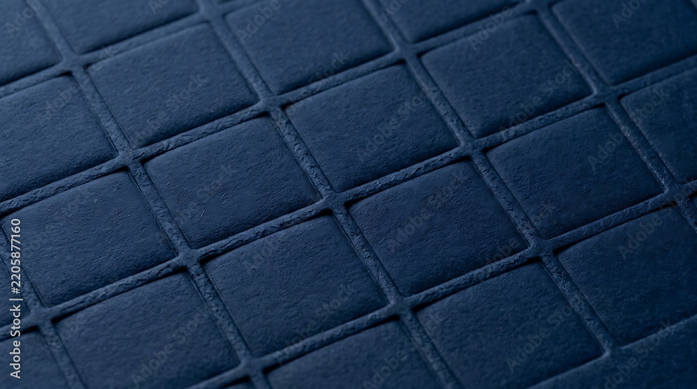 Fototapeta premium A close-up view of a dark blue quilted fabric with a grid pattern, showing soft texture and geometric design.