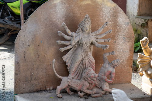 An unfinished clay idol of Goddess Durga slaying Asur inside a traditional workshop at Kumartuli, Kolkata. The image captures the intricate details of heritage clay sculpting, cultural artistry