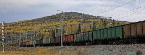 A freight train transports coal in wagons by rail.