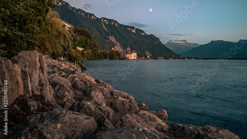 Scenic Alpine Lakeshore with Dramatic Mountains at Dusk