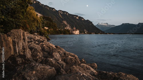 Scenic Alpine Lakeshore with Dramatic Mountains at Dusk
