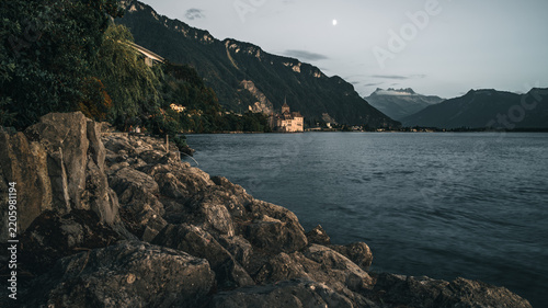 Scenic Alpine Lakeshore with Dramatic Mountains at Dusk
