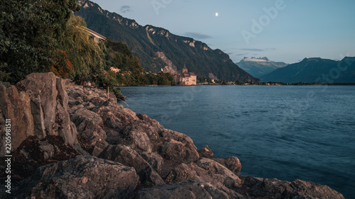 Scenic Alpine Lakeshore with Dramatic Mountains at Dusk