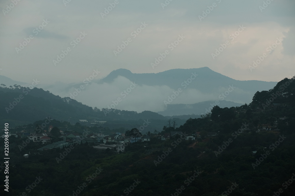 Fototapeta premium Clouds covering Elephant Mountain at sunset in Da Lat, Vietnam