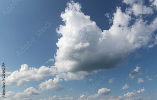 Sky replacement blue sky and large puffy gray and white clouds