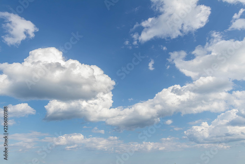 Sky replacement blue sky and spaced out puffy white clouds