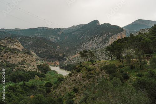 Guadalhorce river winding through a green mountain valley near Caminito del Rey, Spain