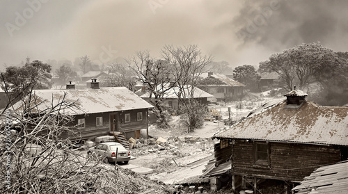 Serene snow-covered village in foggy winter landscape