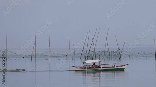 Traditional Fishing Boat Moving Across Calm Coastal Waters