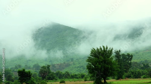 Moving Clouds Over Misty Green Mountains and Countryside