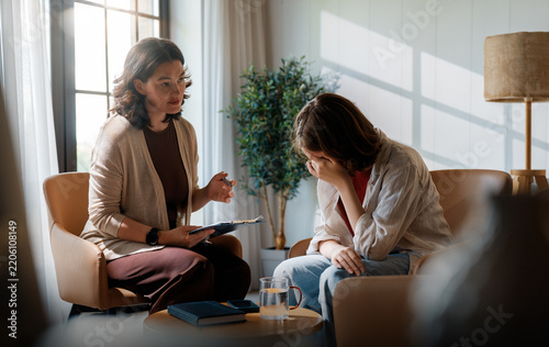 Professional Therapist Comforts Sad Young Woman During Emotional